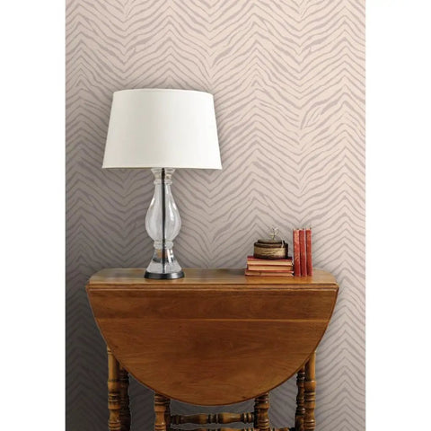 Abstract Animal Textured Vinyl Wallpaper Custom Printed Dope Wallcovering on wall behind a wooden table with a lamp.