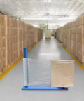 Handheld Manual Stretch Film Pallet Wrapping Dispenser Heavy Duty Packing Machine For Warehouse Logistics No Sweat Setup Handles Big Loads With Ease Supports 132 Lbs Ready To Roll in a warehouse with stacked boxes.