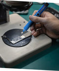 Person using two piece manual desoldering pump solder removal tool suction gun for PCB durable solder sucker on circuit board