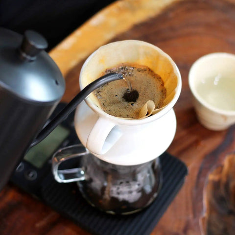 Pouring water over coffee grounds using 500 Pieces Replacement Paper Filters For Aeropress Coffee Makers Round Two Point Five Inch Disposable Unbleached Paper Filters For Espresso And Everyday Brew Sessions.