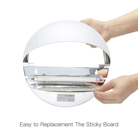 Hands replacing the sticky board in the Silent Wall Sconce Fly Light Trap Kills Mosquitoes Moths And Gnats With UV Glue Boards.