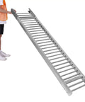 Heavy Duty Unpowered Roller Conveyor With Stainless Steel Frame For Warehouse Loading And Unloading Heavy Boxes Up To 440 Lbs held by a person.