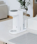 Zero Drama Instant Boiling Water Dispenser And Rapid Chill Formula Preparation Machine on a kitchen countertop.