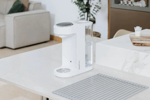 Zero Drama Instant Boiling Water Dispenser And Rapid Chill Formula Preparation Machine on a kitchen countertop.