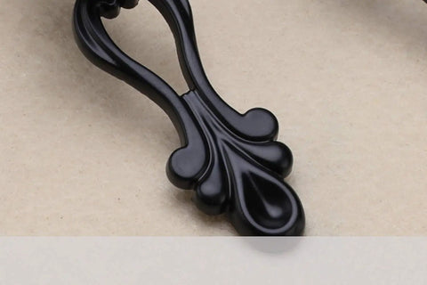 Close-up of a black vintage zinc alloy cabinet handle from the Six Piece Rock Solid Vintage Zinc Alloy Cabinet Handles And Dresser Drawer Pulls With Rust Proof Heavy Duty Hardware Kit For Smooth Wardrobe Cupboard Home Project.