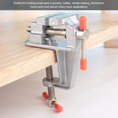 Go To Compact Mini Bench Vise For Jewelry Making And DIY Repairs Space Saving Metal Clamp With 36mm Opening on wooden desk
