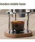 Pneumatic Air Pressure Coffee Machine With Manual Espresso Maker And Cold Brew Brewer Features Adjustable One To Sixteen Bar Hydraulic Gauge on wooden stable base.