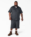 Badass Men Short Sleeve Utility Button Down Workshirt In Charcoal With Stain Resistant Cotton Polyester Blend For Tough Job Site Grind And Easy Relaxed Fit That Handles Every Day Hustle, model wearing charcoal shirt and shorts.