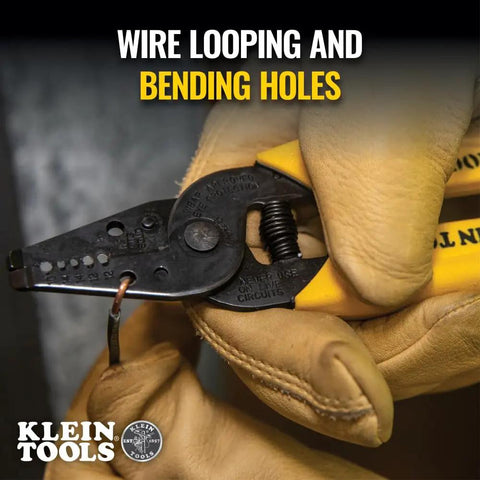 Gloved hand using Built Tough Dual Wire Stripper Cutter For Solid Wire With 14 And 12 AWG Holes Plus 10 AWG Stripping Hole.
