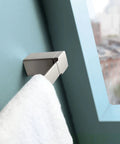 90 Degree 18 Inch Towel Bar In Brushed Nickel on light blue wall with towel hanging, slick modern bathroom accessory with concealed mounting