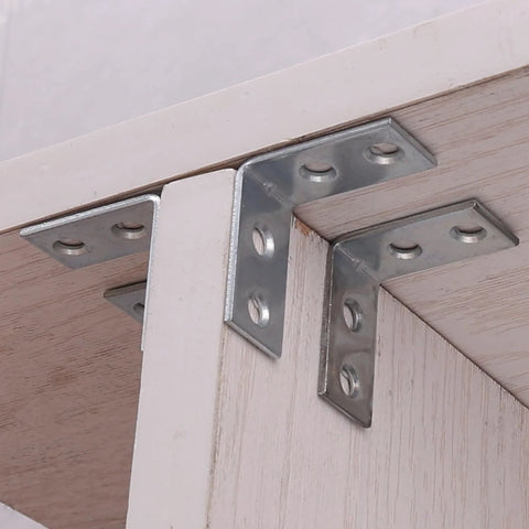 10 Pack Right Angle Corner Brackets For Furniture And Cabinets installed on wooden shelf, silver iron joint fasteners for heavy duty support.