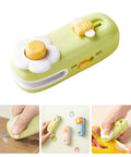 No Sweat Mini Bag Sealer and Cutter, Easy Peasy 2 In 1 Heat Resealer for Chip Bags, Portable Handheld Plastic Bag Sealer Machine and Versatile Mylar Food Packaging Tool in Green, shown in close-up with user hand.
