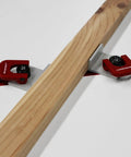 Heavy Duty 4 Pack T Track Cam Stops With Slam Tight Levers For Woodworking Jigs And T Slot Rails shown holding a wooden board.