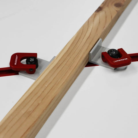 Heavy Duty 4 Pack T Track Cam Stops With Slam Tight Levers For Woodworking Jigs And T Slot Rails shown holding a wooden board.
