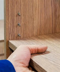 Close-up of wood shelf supported by wall mount pins for Heavy Duty Shelf Brackets For Bookshelves Cabinets And Home Office Organization.