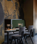 Dining table with Cordless Desk Lamp With USB Charging, Portable LED Table Light, compact and rechargeable, in a stylish restaurant.