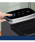 Top view of Premium Compact Countertop Electric Ice Maker With Effortless Manual And Automatic Settings, hand pressing control.