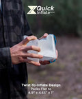 Person holding Go To Solar Camping Lantern with 8 Color Modes and Twist to Inflate LED Lamp, showing compact design.