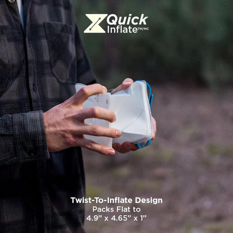 Person holding Go To Solar Camping Lantern with 8 Color Modes and Twist to Inflate LED Lamp, showing compact design.