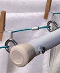 Eight Piece Eye Bolts With Nuts Set For Hanging And Tie Downs Five Sixteenth Inch By Three And One Quarter Inch Steel Zinc Plated Fasteners used with cables in a utility setup.