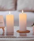 White Flameless Candles Set Of 2 2.2x5 Inch LED Pillar Candles With Remote, Timer, Battery Operated, Dimmable, on a table