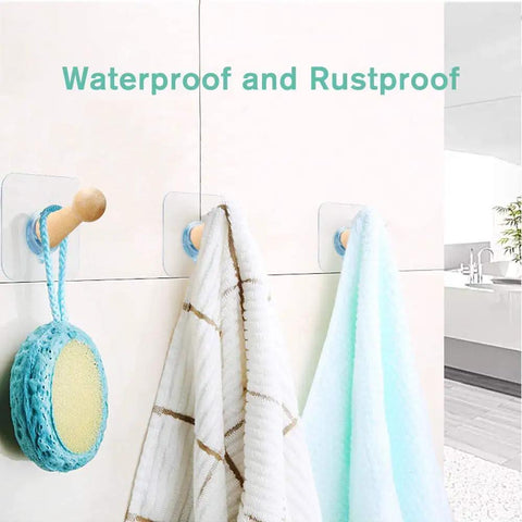 Adhesive Hat Hooks For Wall Or Door Eight Pack Wooden Peg Hat Hangers holding towels and sponge in bathroom setting, waterproof.