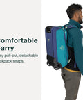 Person carrying collapsible wheeled carry on duffel with backpack straps