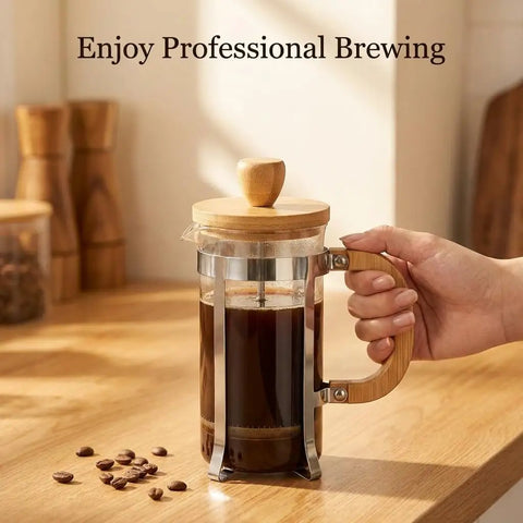 12 Ounce French Press Coffee Maker with Stainless Steel Filter and Borosilicate Carafe, bamboo handle, one cup brew on table