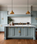 Modern kitchen with blue cabinets featuring Antique Brass Cup Pulls Zinc Alloy Cabinet Hardware, 5 Inch Center, 6 Pack.