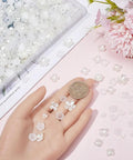 600Pcs Flower Bead Caps Set White And Clear 3 Petal 4 Petal 5 Petal Tulip Petal End Caps shown in hand with coin for scale