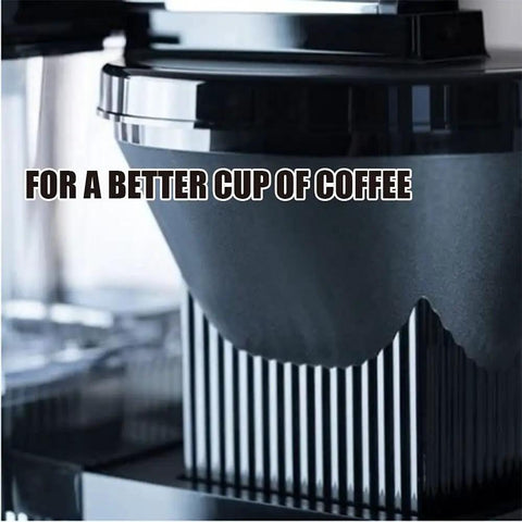 Close-up of a stainless steel drip coffee maker with thermal base, featuring automatic and hand brew modes. Filter section shown.