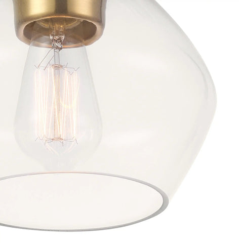 Close-up of Harrow 1 Light Semi Flush Mount Ceiling Light In Matte Brass With Clear Glass Shade, showing bulb and brass fixture.