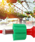 Front view pressure relief valve with green body, red knob, and metal spring for backpack garden sprayer.
