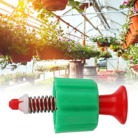 Front view pressure relief valve with green body, red knob, and metal spring for backpack garden sprayer.