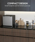 Real Deal 1.1 Cubic Foot Upright Mini Freezer With Quick Dial Thermostat and Smooth Reversible Door in compact kitchen setting.