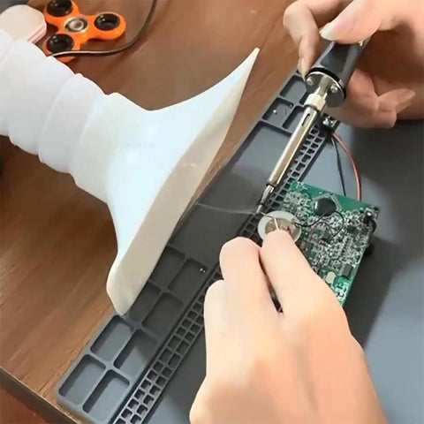 Heavy Duty Solder Fume Extractor With Adjustable Speed Knob And Three Stage Filtration Quiet Air Cleaner For Welding Grinding And Workshop Crews, used for soldering a circuit board.