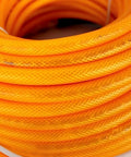 1/4 Inch By 100 Feet Hybrid Polymer Air Hose With Bend Restrictors Ultra Lightweight coiled in orange, ideal for heavy duty compressor use.