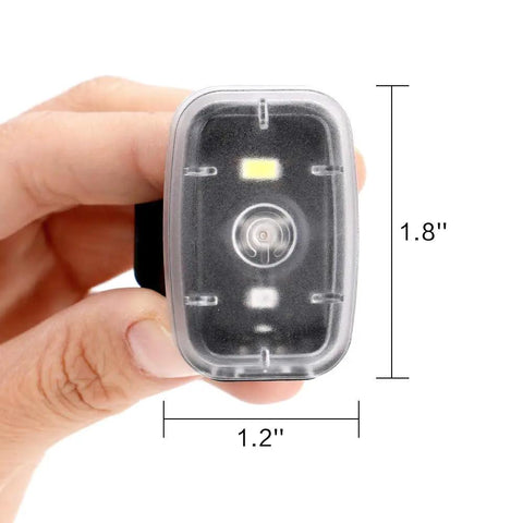 Hand holding compact 1.8x1.2 inch Clip On Safety Light For Night Running And Cycling With Five Modes, High Visibility Tail Light