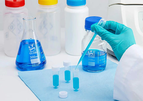 Close-up of Globe Scientific 5ml sterile polypropylene transport tubes with attached white caps and conical bottoms