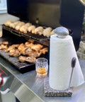 Granite Paper Towel Holder Free Standing Kitchen Roll Holder With Durable Granite Base next to outdoor grill with food.
