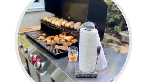 Granite Paper Towel Holder Free Standing Kitchen Roll Holder With Durable Granite Base next to outdoor grill with food.