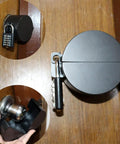 Door knob lockout device, black metal, with padlock; housing and mounting bracket prevent knob turning and key access.