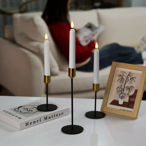 Flameless Flickering LED Taper Candles 7 Inch Ivory Plastic Roman Column on black stands, remote controlled, set of 3