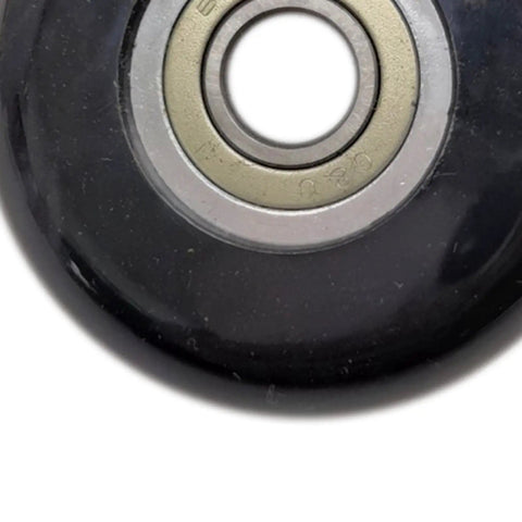 Close-up of Universal Bearing Pulley Wheel For Gym Cable Systems And Home Workout Setup, black PP roller with bearing