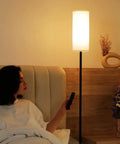 Tall Minimalist Floor Lamp for Living Room and Office with White Fabric Lampshade near bed