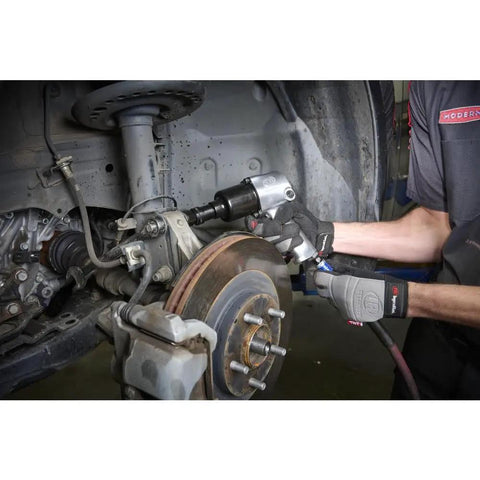 Mechanic using 231C Half Inch Drive Air Impact Wrench With Beefy 600 Ft Lbs Torque, 8000 RPM, Twin Hammer on car suspension