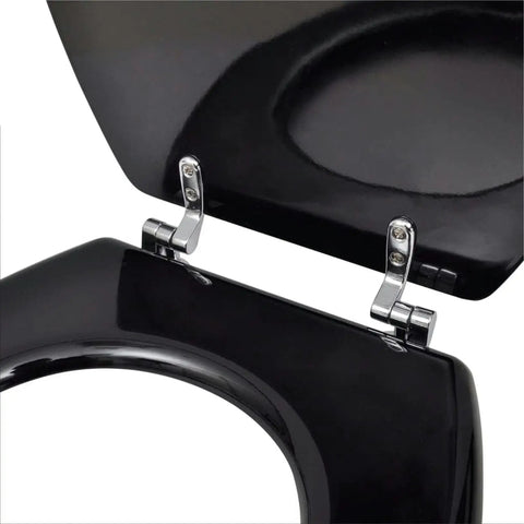 Close-up of chrome hinge on black toilet seat, showcasing the high-quality design of Straight Up Comfy Flannel Toilet Seat Covers With Lids Two Pack Seamless Slide On Design Heavy Duty Water Resistant Black For Most Round Bowls Zero Hassle Mount Clean Slick Vibe.