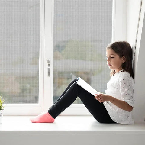 Child sitting by window with screen, illustrating No Brainer Handy DIY Window And Patio Screen Repair Kit With 36 By 90 Inch Fiberglass Mesh.