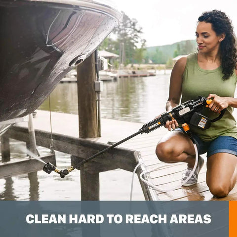 Woman using Deluxe Accessory Kit For Hydroshot Power Washers cleaning under boat with brush and soap dispenser on dock.