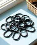 12 Pack Durable Plastic C Shape Shower Curtain Rings With Smooth Glide For Easy Hanging arranged on a blue table